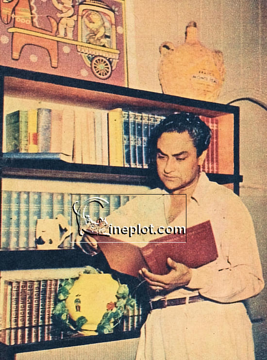 Ashok in his den, among his books. On the wall is painting by Jamini Roy.