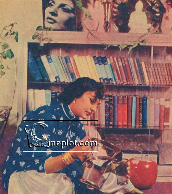 Sitting in the bedroom on the carpet before the bookcase, Nadira makes herself a lemonade.